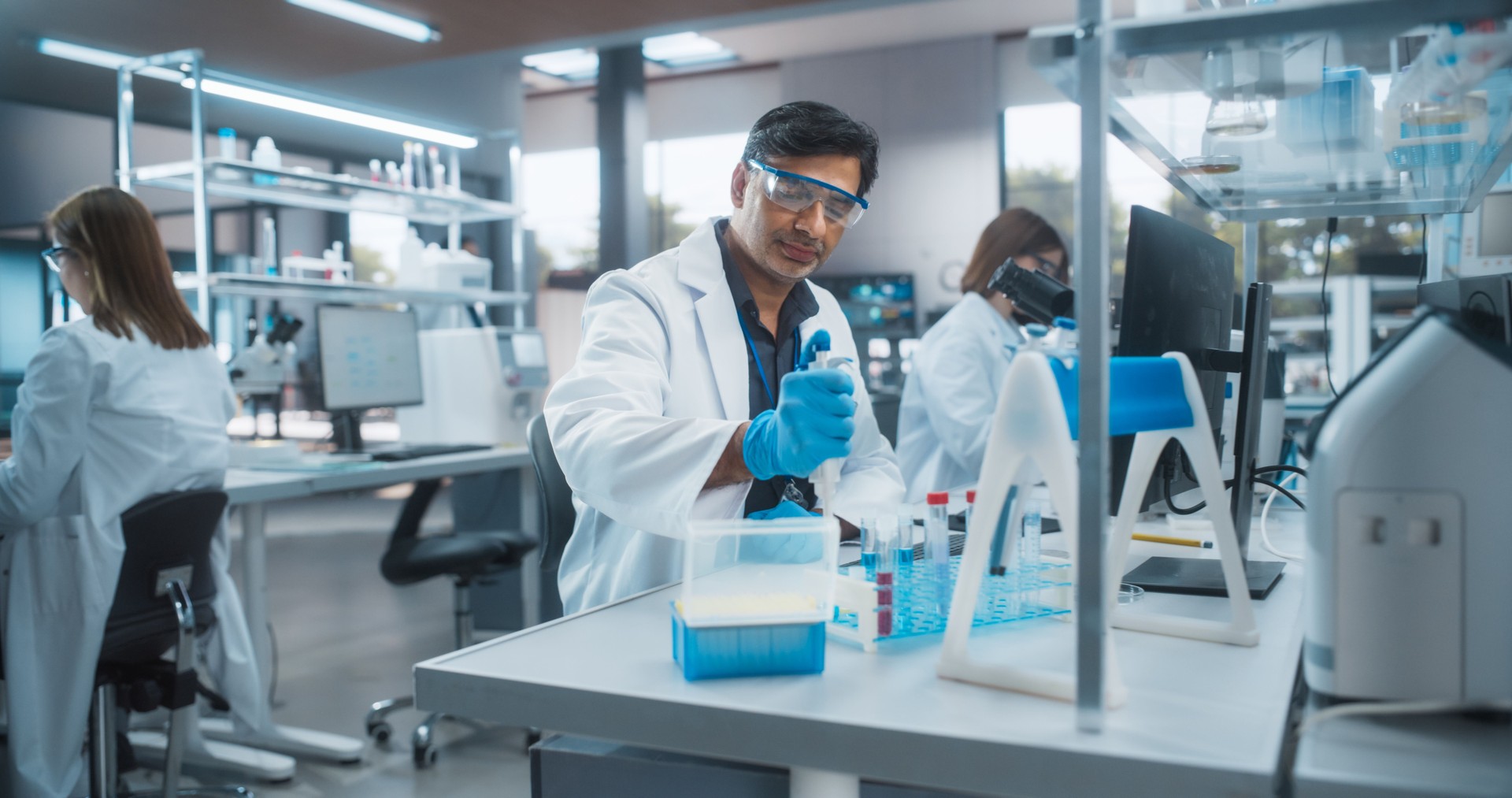 Medical Research Laboratory: Portrait of a Handsome Indian Scientist Using Micropipette for Test Analysis. Advanced Scientific Lab for Medicine, Biotechnology, Microbiology Development